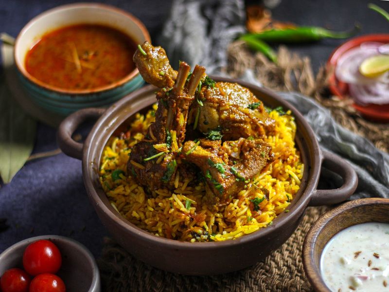 Mutton biryani with raita and gravy