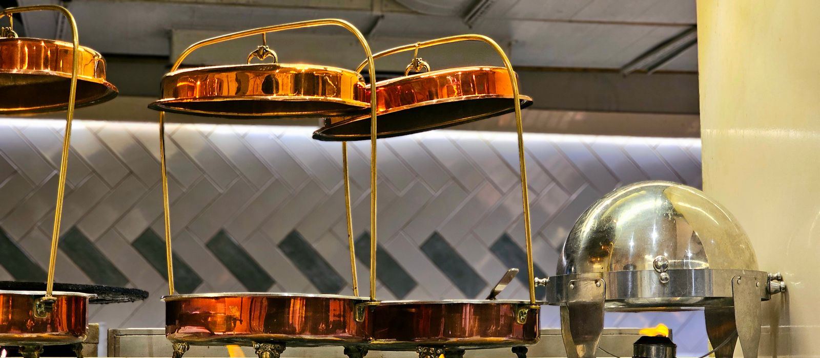 Copper chafing dishes on a buffet counter